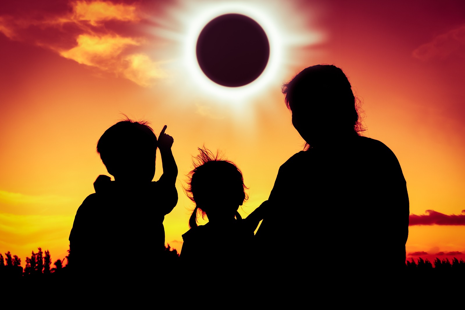 sombra de tres mirando mirando a lo lejos el eclipse
