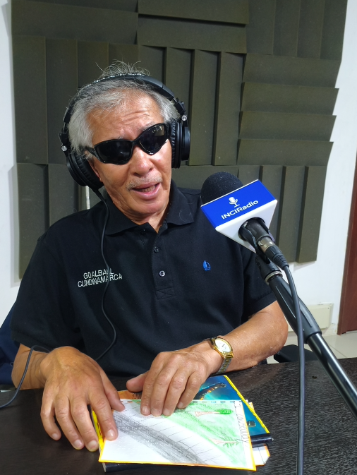 wilson villa está frente al micrófono, con sus dedos lee su información