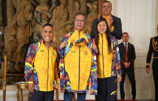 el presidente de la republica el doctor Gustavo Petro junto a dos de los abanderados paralímpicos sonríen