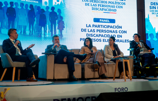 Panel del foro "Democracia sin barreras" sobre la participación de las personas con discapacidad en los procesos electorales. En el escenario, cinco panelistas, entre ellos la directora del INCI, Andrea Carolina Chacón Castillo, participan en una conversación sobre los derechos políticos y la inclusión de las personas con discapacidad.